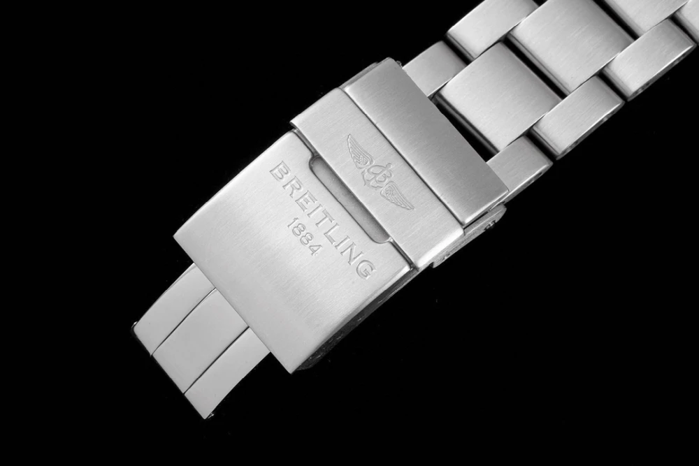 Close-up of Breitling 1884 engraved stainless steel deployant clasp on metal watch bracelet