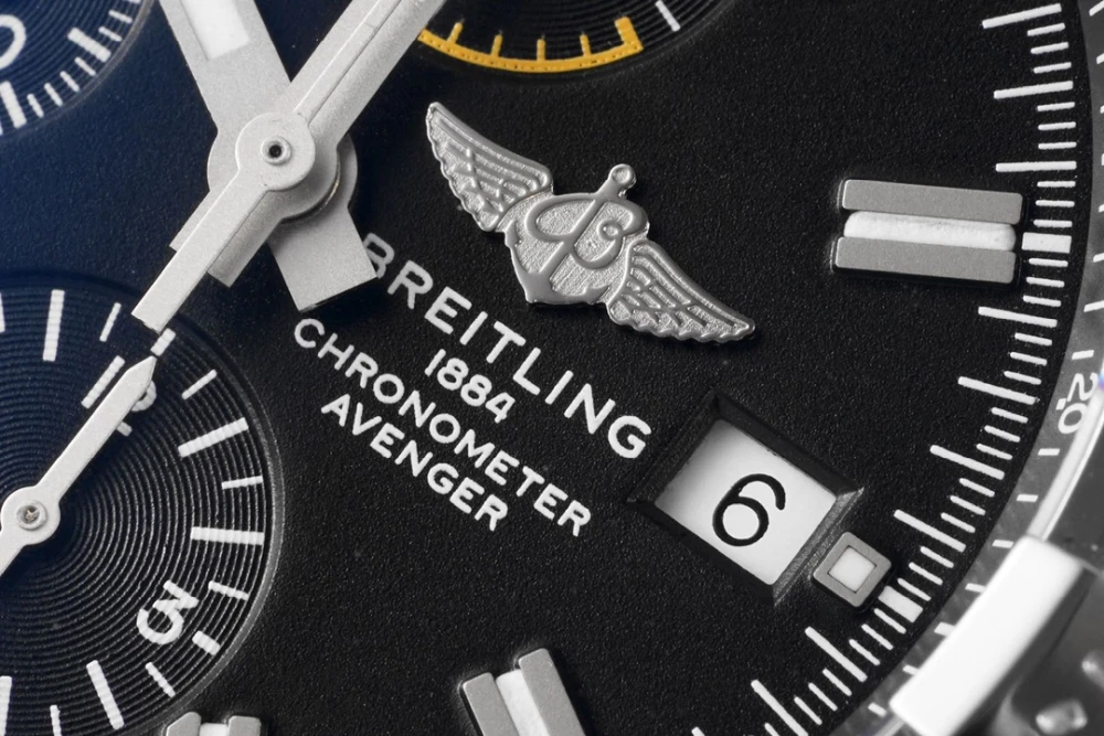 Macro shot of Breitling Avenger dial with winged logo, chronometer inscription and date window at 3 o’clock