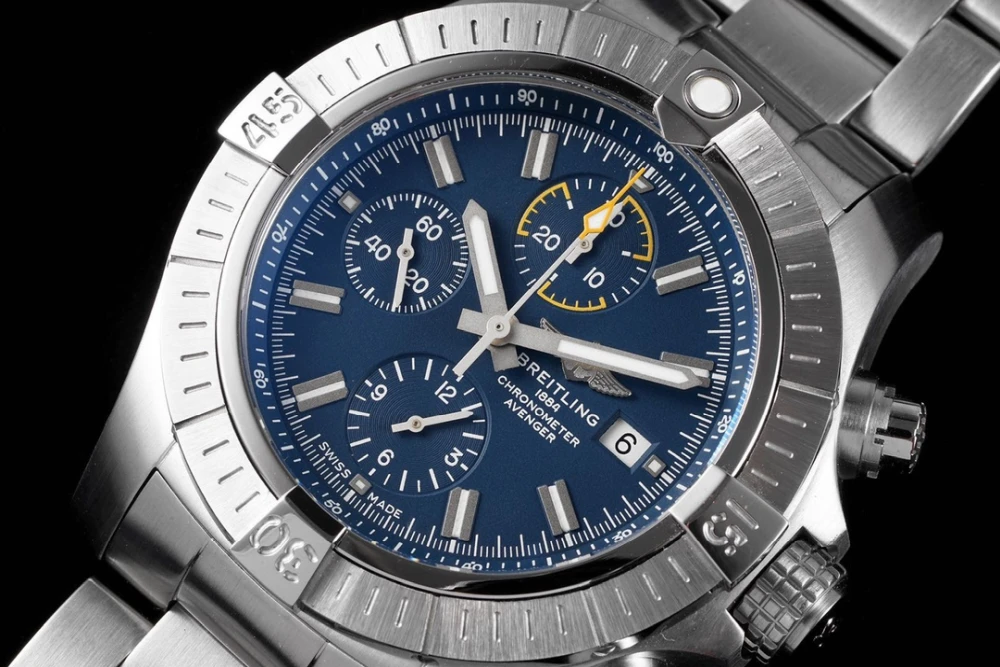 Macro shot of Breitling Avenger 45mm blue dial with winged logo, chronometer inscription and date window at 3 o’clock