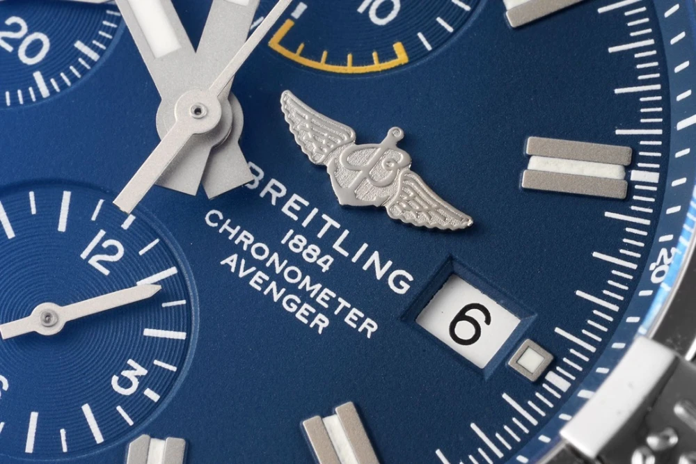Macro shot of Breitling Avenger 45mm blue dial with winged logo, chronometer inscription and date window at 3 o’clock