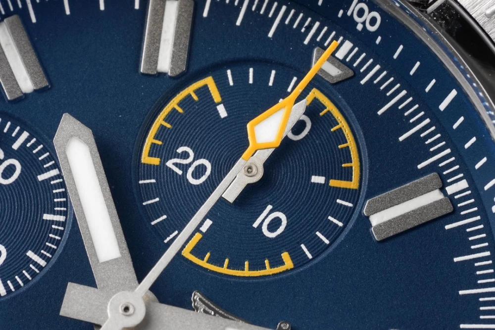 Detailed view of Breitling Avenger chronograph 45mm blue subdial with yellow accent markings and luminous hands