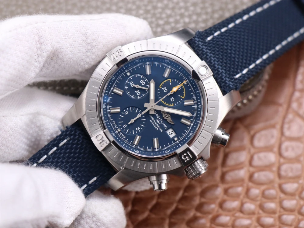 Breitling Avenger Chronograph A13317101C1X1 replica on blue canvas strap, brushed stainless steel bezel, and blue dial with applied hour markers left view