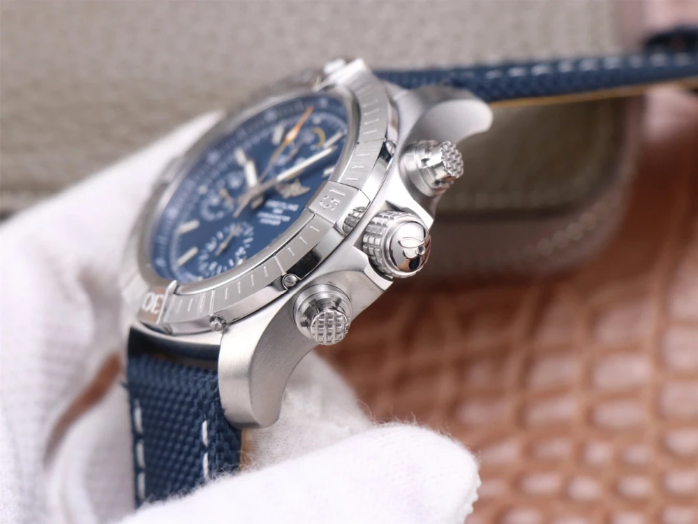 Breitling Avenger Chronograph side view, stainless steel case with knurled crown and chronograph pushers, blue canvas strap