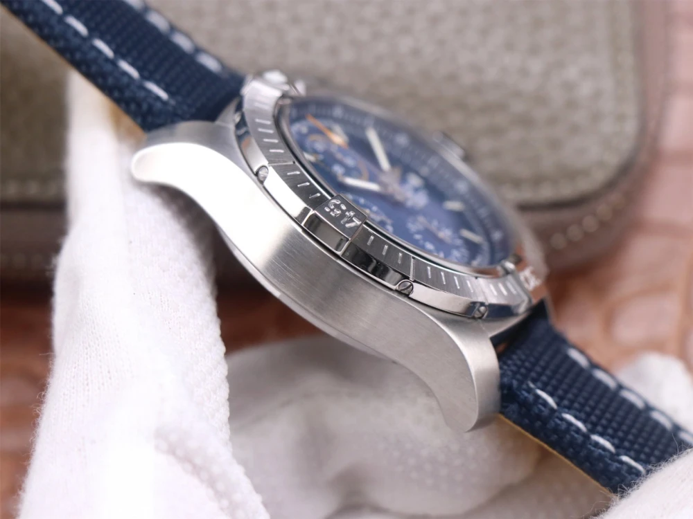 Breitling Avenger Chronograph A13317101C1X1 replica brushed stainless steel case side, unidirectional rotating bezel, and navy-yellow canvas strap