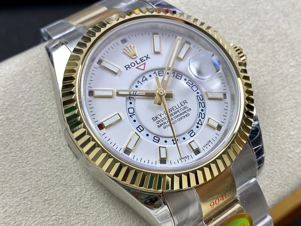 Close up of the Rolex Sky Dweller white dial featuring annual calendar and 24 hour GMT function with gold hour markers and hands