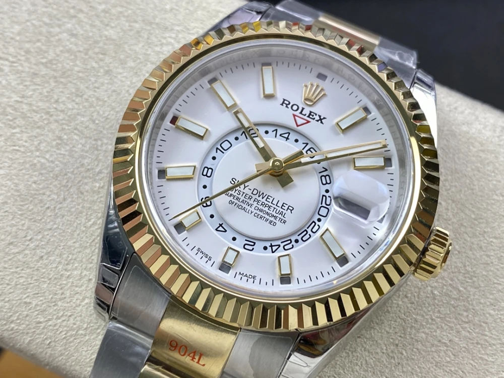 Close up of the Rolex Sky Dweller white dial featuring annual calendar and 24 hour GMT function with gold hour markers and hands 