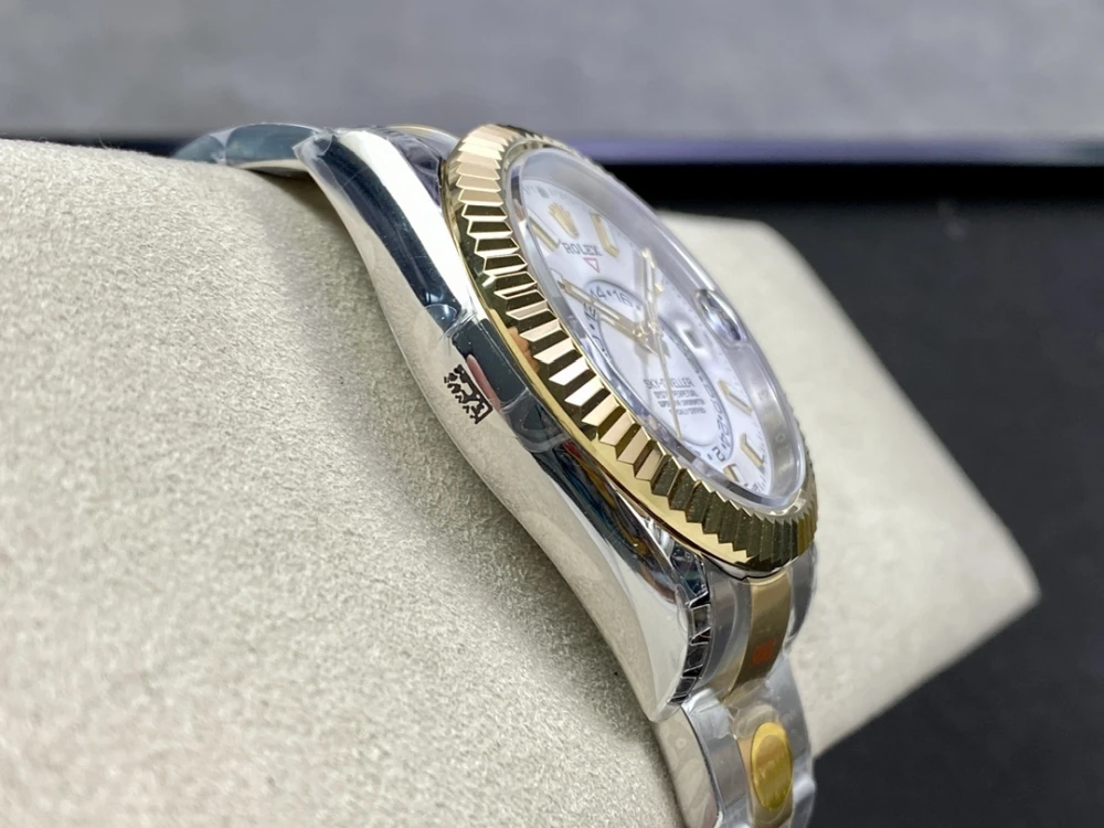 Side view of the Rolex Sky Dweller two tone case showing the 18K yellow gold fluted bezel and stainless steel mid case