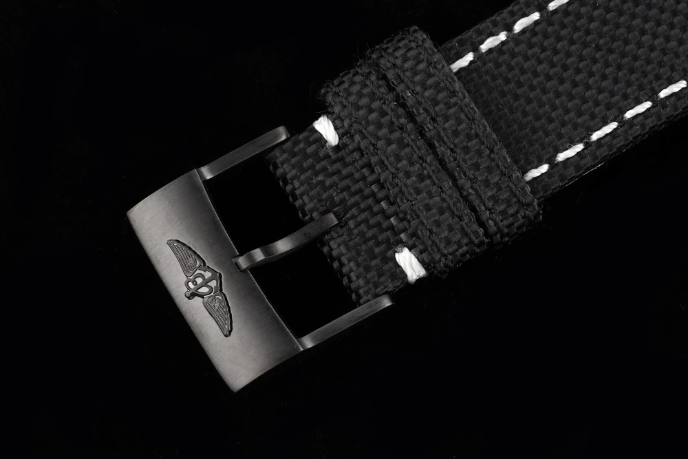 Breitling Avenger Chronograph black DLC-coated case with black canvas strap, white contrast stitching, and engraved winged logo buckle