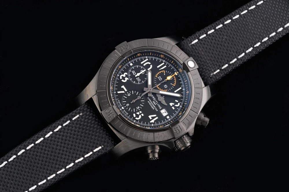 Breitling Avenger Chronograph on black canvas strap, black DLC-coated case, black dial with white Arabic numerals