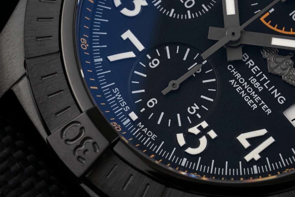 Close-up of Breitling Avenger Chronograph dark blue dial with 'SWISS MADE' text, white Arabic numerals, and 6 o'clock sub-dial