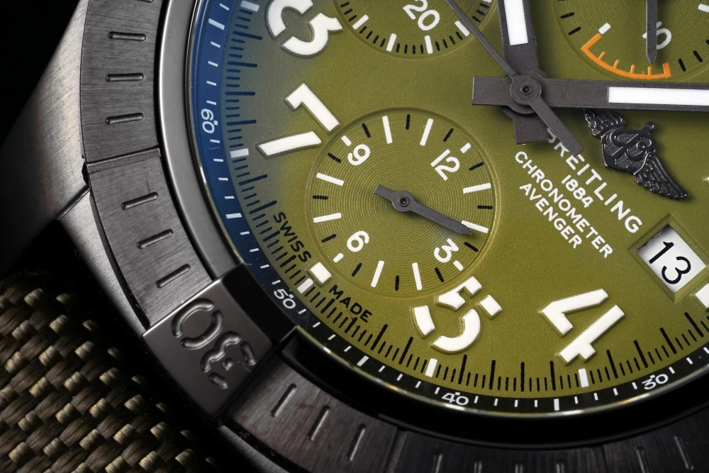 Close-up of Breitling Avenger Chronograph V13317101L1X1 Green dial with 'SWISS MADE' text, white Arabic numerals, and 6 o'clock sub-dial