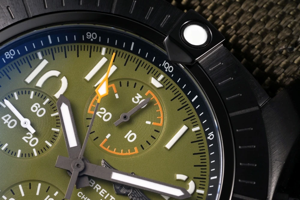 Close-up of Breitling Avenger Chronograph blue Reflective Green dial with Yellow-accented 30-minute counter and applied hour markers