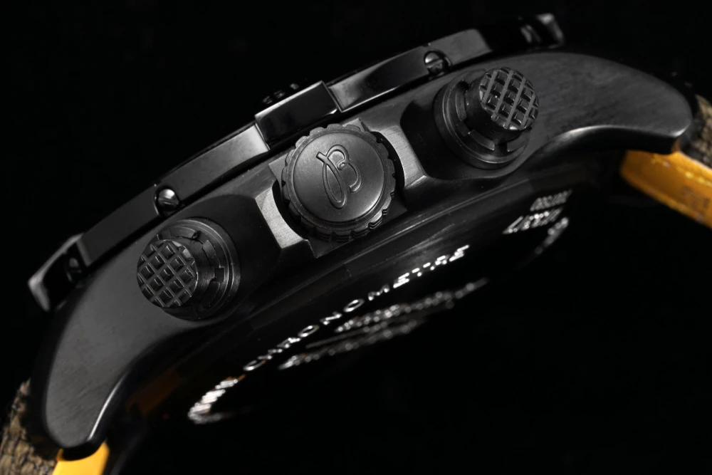 Side profile of Breitling Avenger Chronograph V13317101L1X1 black DLC case with textured chronograph pushers and B-logo crown