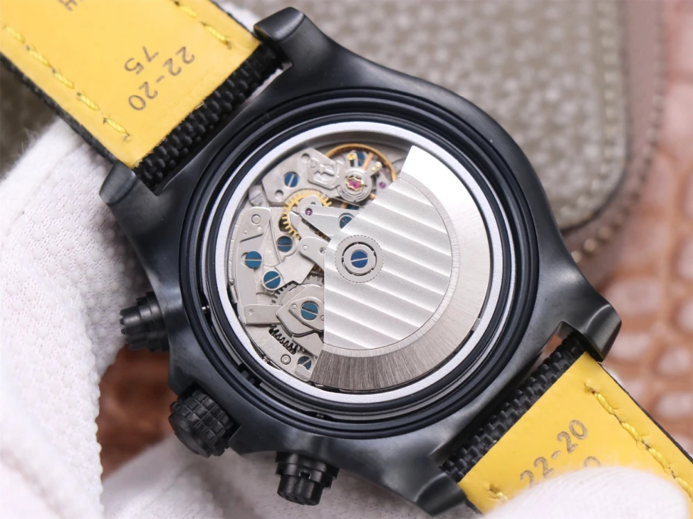 Breitling Avenger Chronograph V13317 replica open case back showing automatic movement with Côtes de Genève finish, black DLC case and yellow leather-lined canvas strap