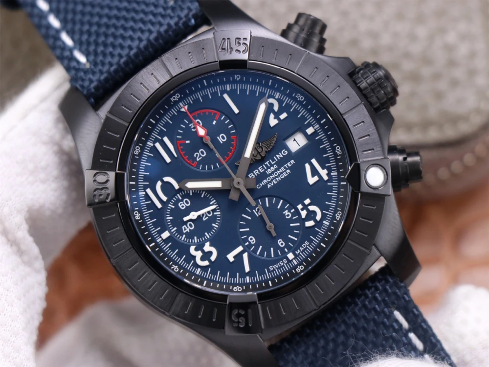 Close-up of Breitling Avenger Chronograph replica blue dial, white Arabic numerals, red-tipped chronograph hand and date window at 3 o'clock